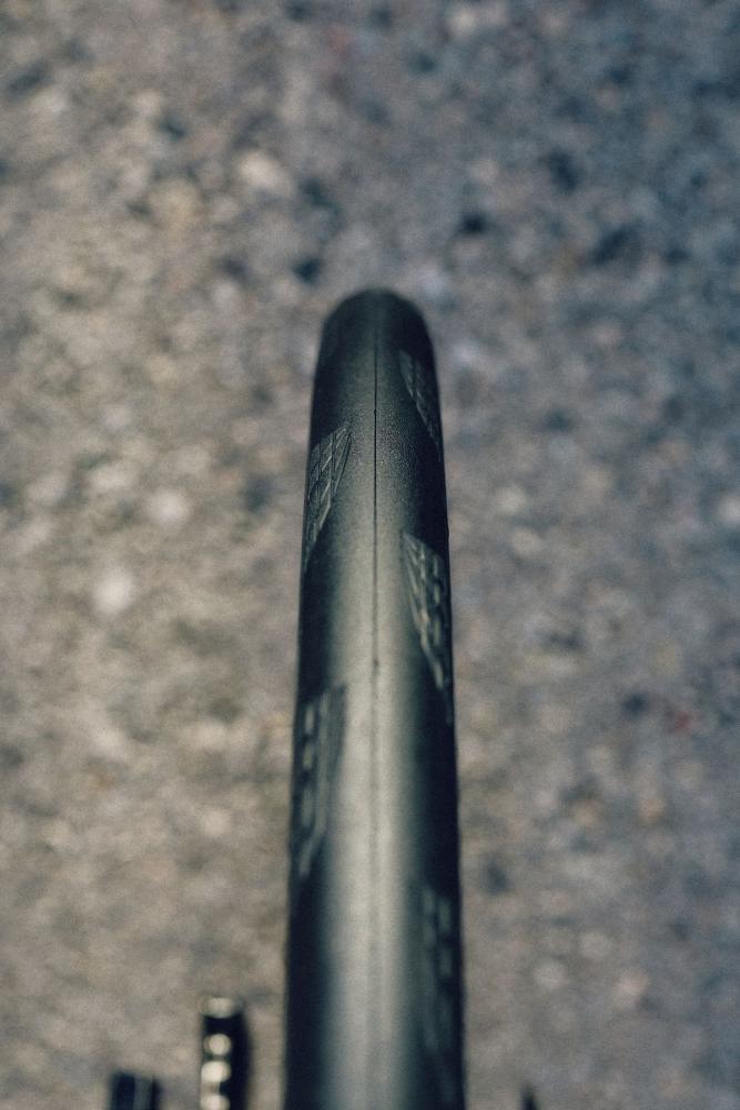 Continental Grand Prix 5000 S TR Tubeless-Ready 700x28C Faltreifen, schwarz, Detailaufnahme des Profils auf Asphalt.
