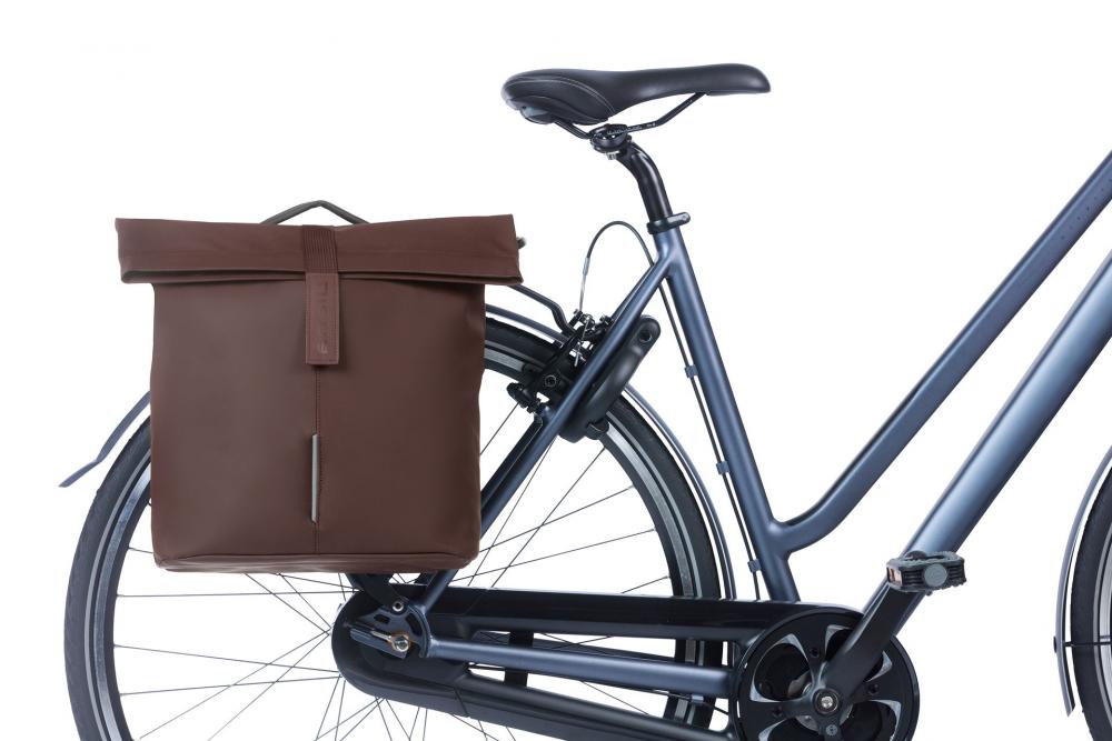 Braune BASIL City Doppeltasche MIK 2.0 aus veganem Leder mit wasserfestem Rollverschluss am Fahrrad.