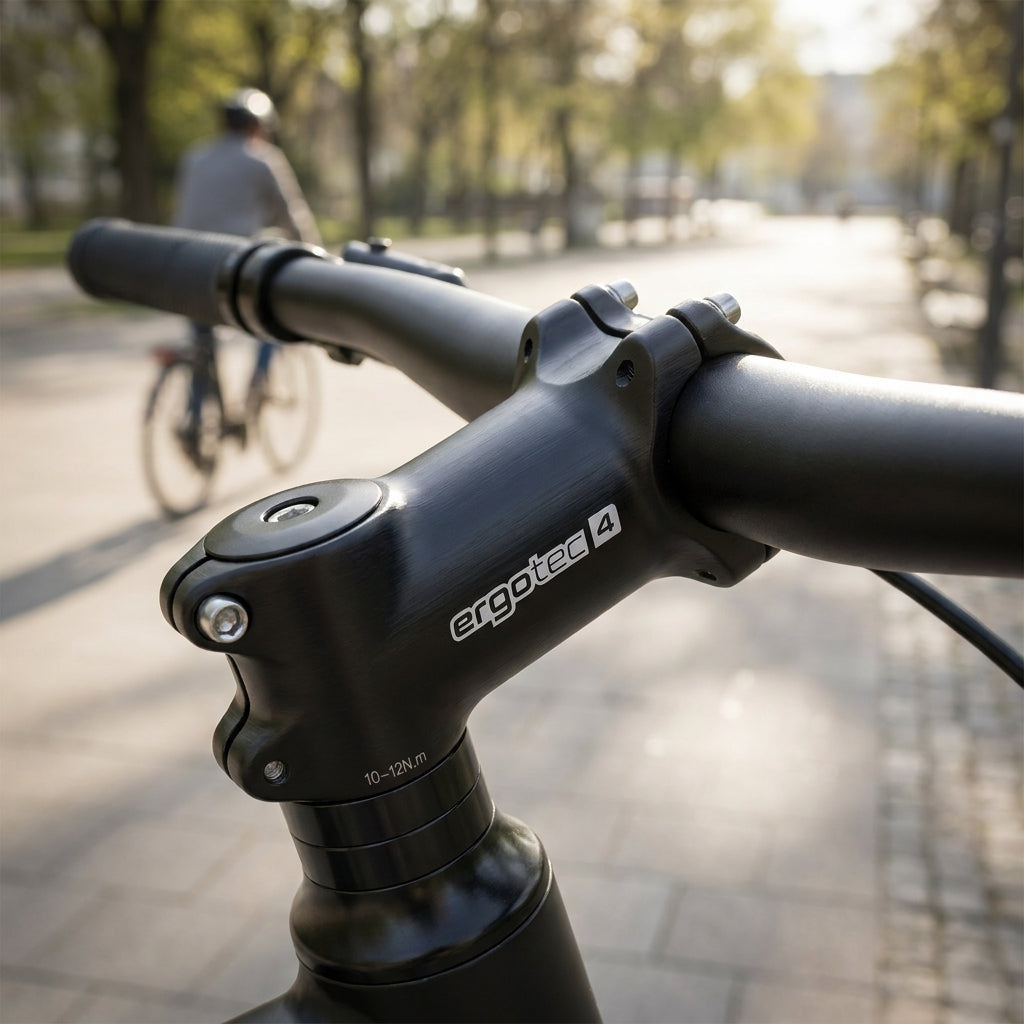 Ergotec AHEAD Vorbau High Crab 2 Alu schwarz, Nahaufnahme am Fahrradlenker, Radfahrer fährt im Hintergrund.