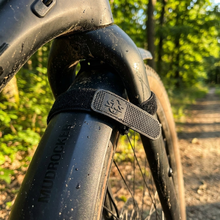 Schwarzes SKS Klettband am Mudrocker Schutzblech eines Mountainbikes auf Waldweg. Gummiert für sicheren Halt.
