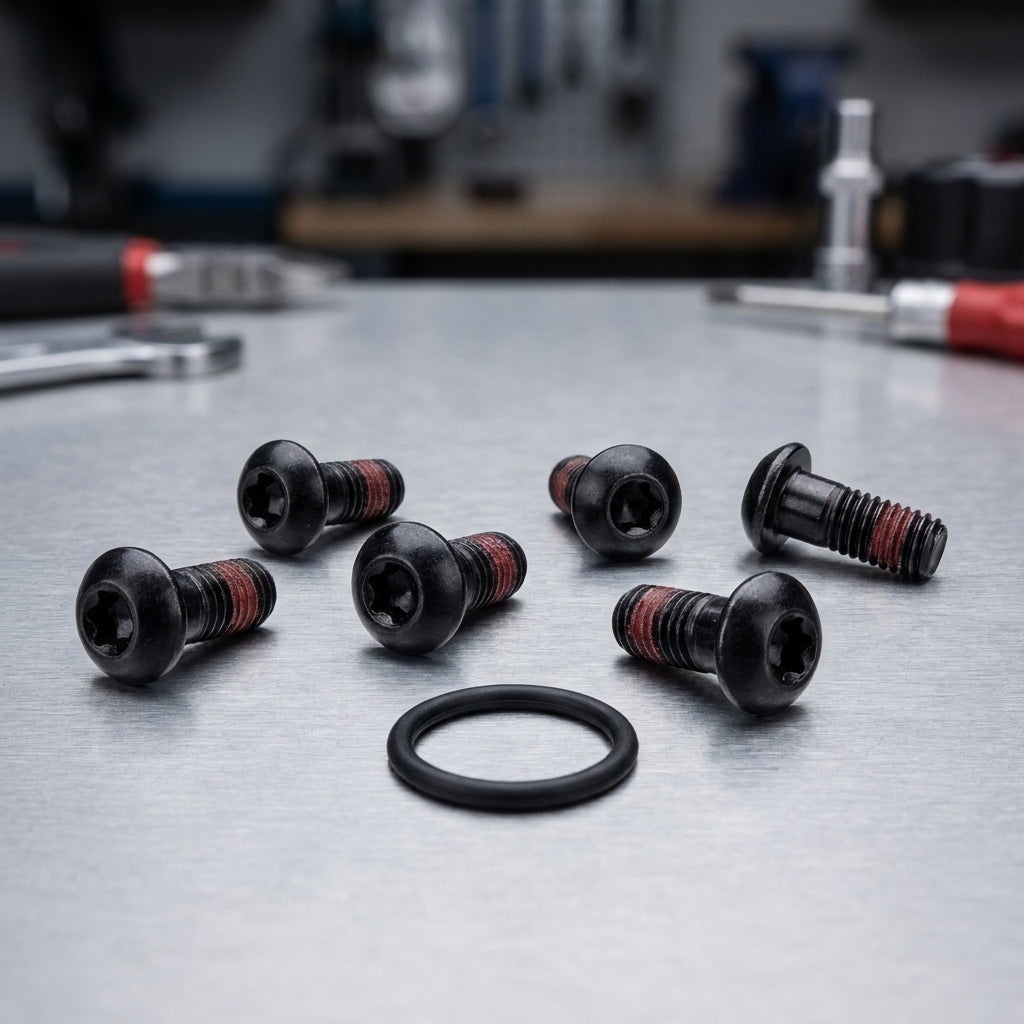 Sram Speed-Ring Montage-Kit mit schwarzen Schrauben und O-Ringen für Fahrräder auf Werkbank.