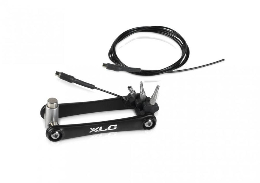 Schwarzes XLC Spezialwerkzeug TO-S86 für interne Fahrrad-Kabelverlegung, mit Führungskabel und Adaptern.