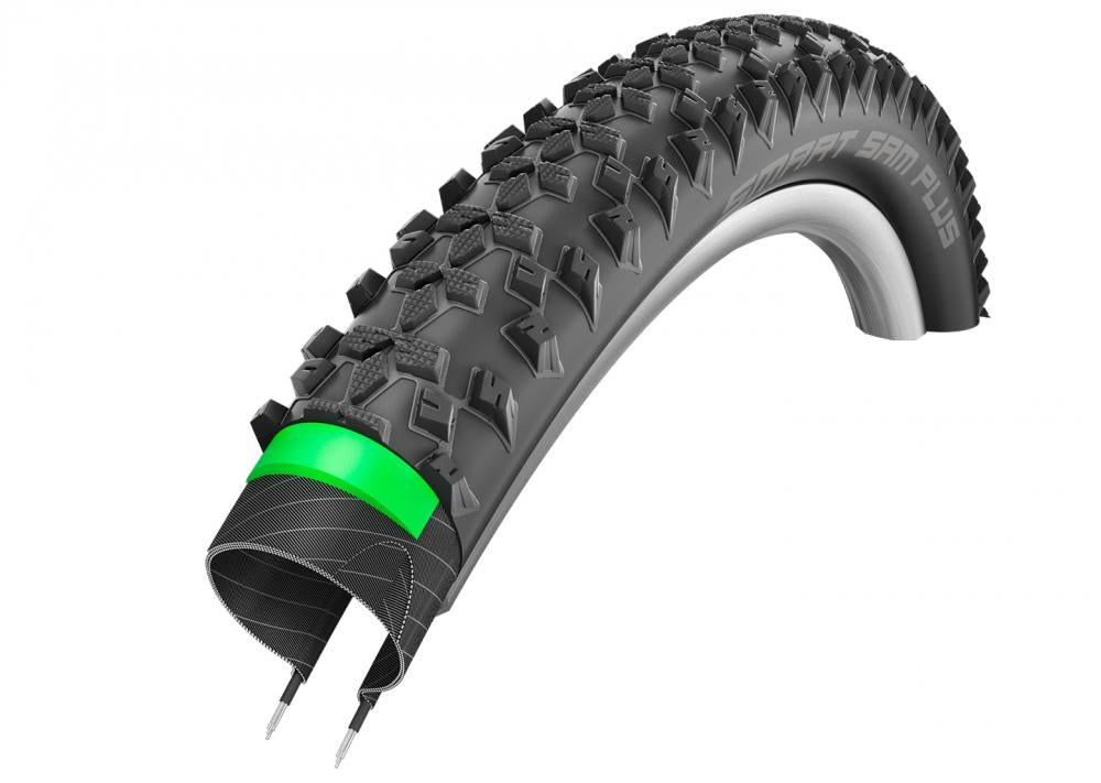 Schwalbe Smart Sam Plus Fahrradreifen Querschnitt mit grobem Profil und grüner Pannenschutzlage.
