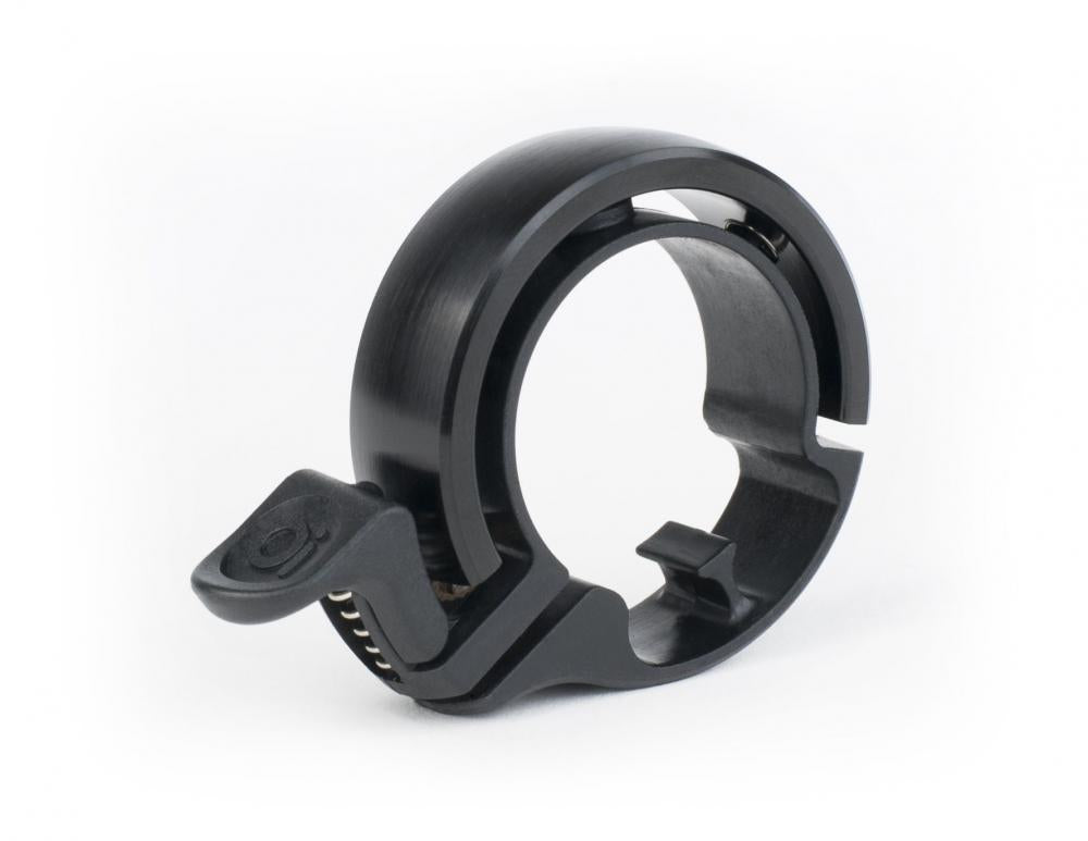 Knog Oi Classic Fahrradklingel Large in Schwarz für 23,8-31,8 mm Lenker, minimalistisches Ring-Design.