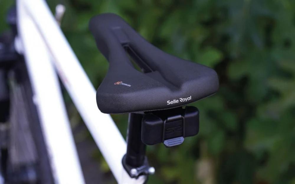 Schwarzer Selle Royal Vaia Moderate Unisex Sattel mit Multitool auf weißem Fahrrad.